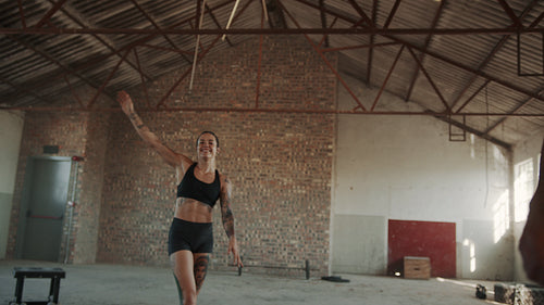 Muscular woman doing the deadlift workout in gym