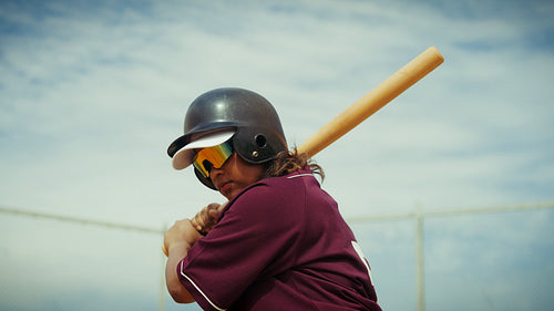 Female baseball batter takes a powerful practice swing
