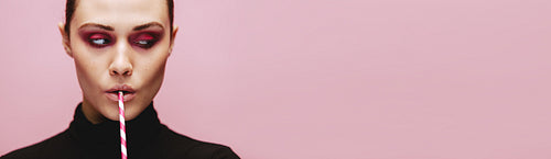 Woman with straw looking at side