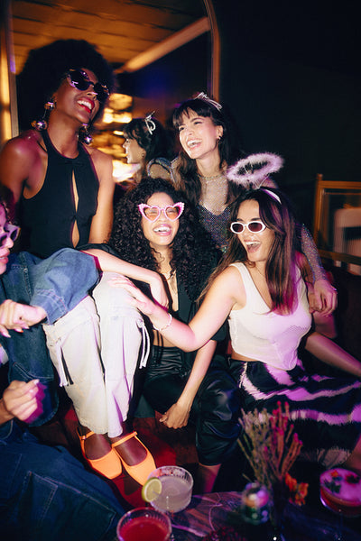 Group of friends in costumes enjoying a lively evening together