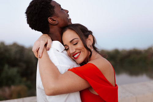 Young woman embracing her boyfriend affectionately