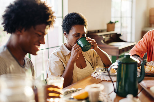Brazilian family enjoying a homemade breakfast, sipping on café coado