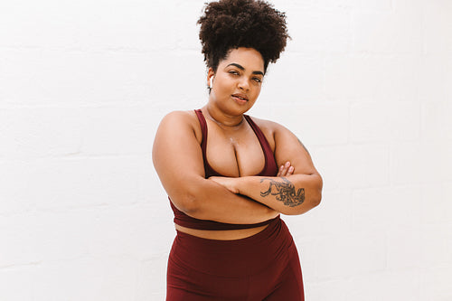 Confident fitness woman with her arms crossed