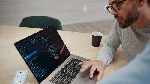 Computer coding: Business men working on a software design in an office