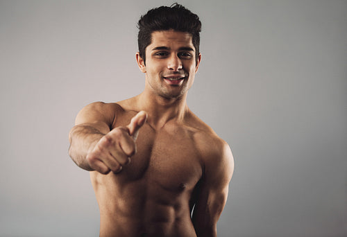 Shirtless young hispanic man wishing you good luck