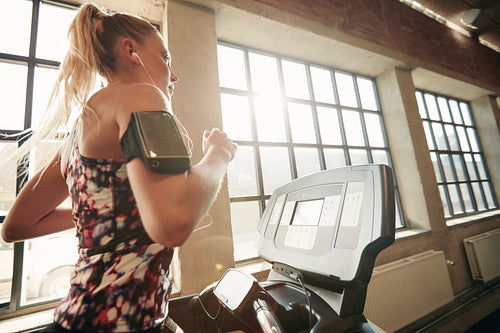 Female working out on a treadmill at gym
