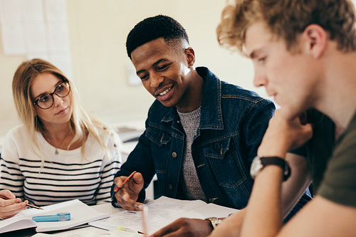African boy studying with classmates