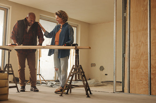 Couple renovating their home with some carpentry woodwork