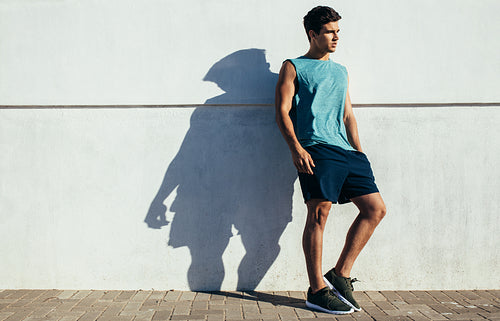 Fit young male relaxing after running exercise