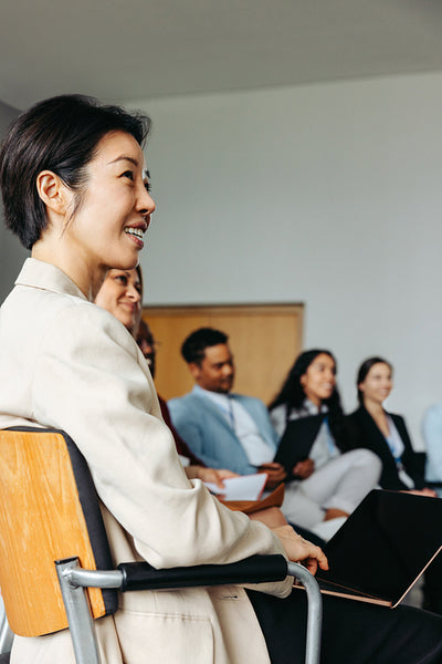 Successful businesswoman of Asian ethnicity smiling during a business meeting