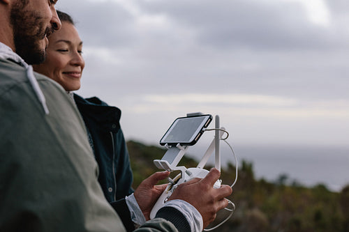 Couple using aerial drone for photography