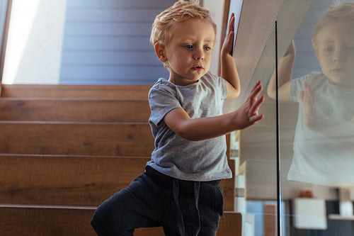 Little boy coming down stairs