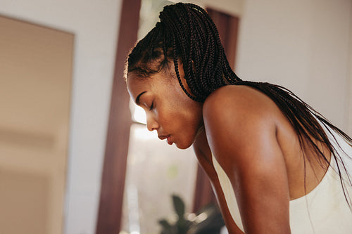 Woman taking a break from a workout in her home gym