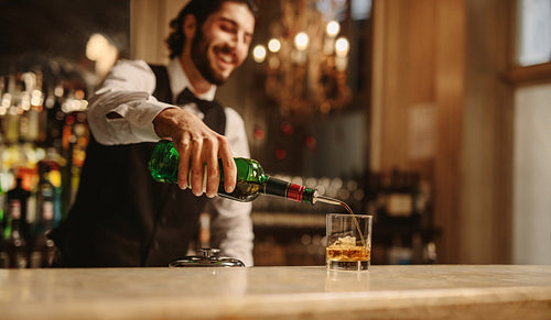 Bartender preparing a drink for guest