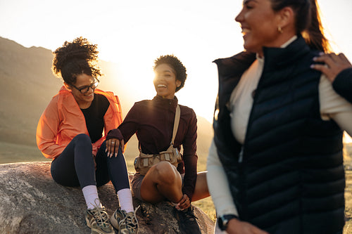 Friends laughing together outdoors on hike