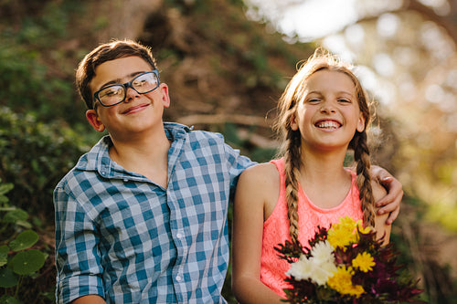 Portrait of happy kids in love sitting in park