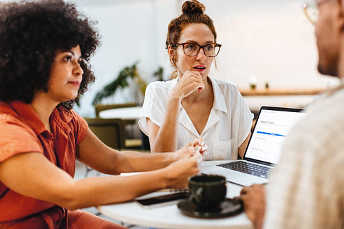 Collaborative business team working on a project in a coffee shop