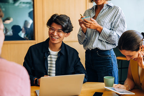 Group of young professionals in a casual business meeting setting