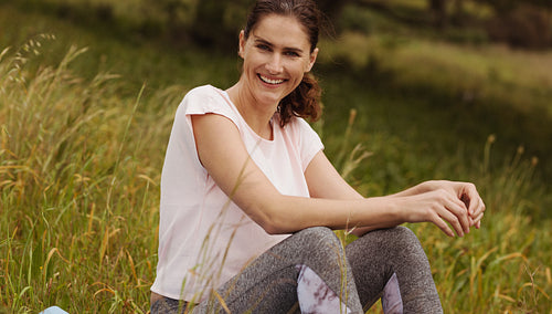 Woman enjoying nature sitting in a park