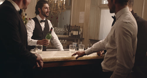 Bartender serving drinks to men at party