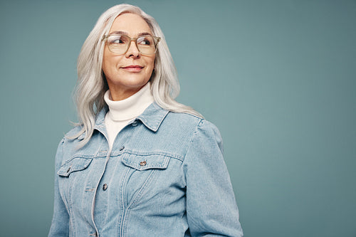 Thoughtful mature woman looking away in a studio