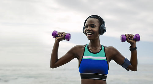 Fitness woman doing workout with dumbbells