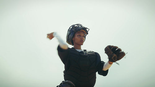 Young catcher practices her throwing skills on the field