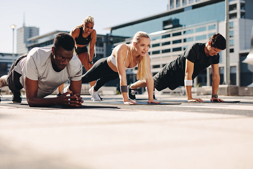 Fitness group working out together in the city