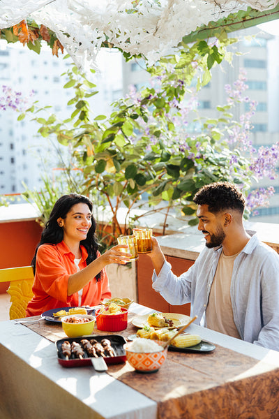 Couple enjoying a homemade meal together on a rooftop terrace