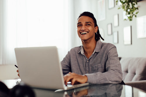 Smiling young businessman at home
