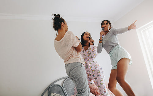 Girls at a sleepover singing and dancing