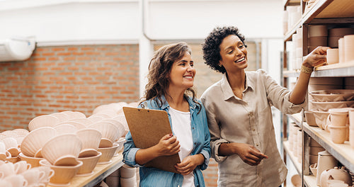 Happy ceramic shop owners having a dicussion in their store