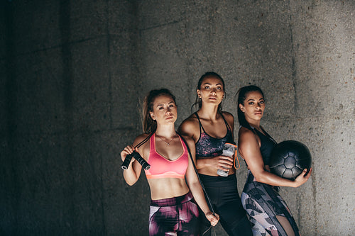 Female friends standing together after workout session