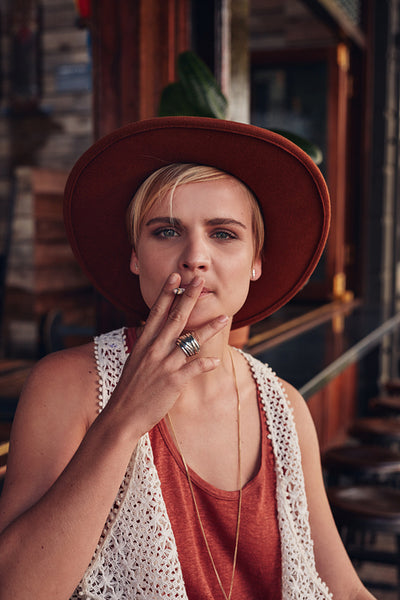 Young woman smoking a cigarette in coffee shop