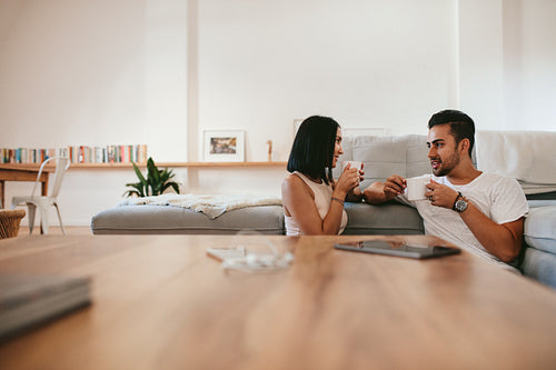 Young couple having coffee at home