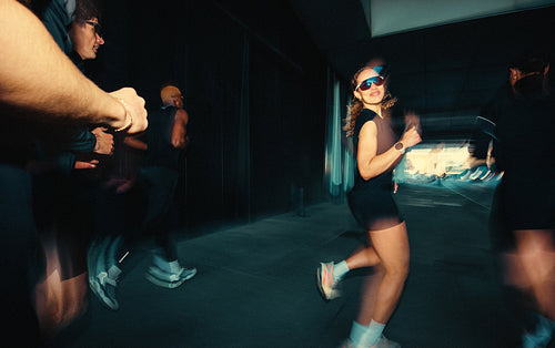 Urban running with a woman leading the group through city training