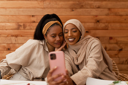 Best friends taking a selfie together in a restaurant