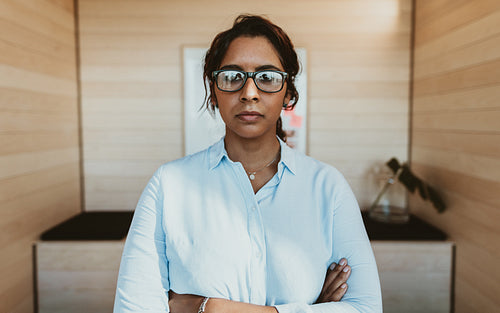 Confident young businesswoman standing in office