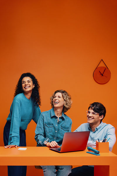 Creative team in monochromatic orange set with colorblocking elements