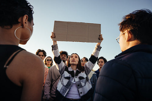 Group of passionate protestors holding a blank sign during a demonstration
