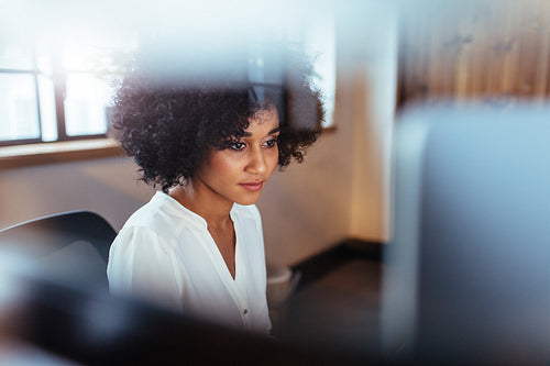 Young african woman working in her office