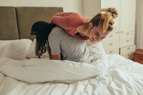 Couple having fun on bed at home
