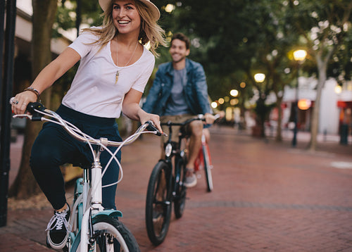 Woman enjoying cycling outdoors with friends