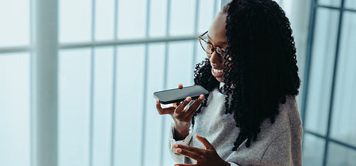 African businesswoman communicating confidently using a smartphone