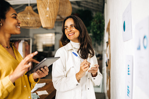 Two female entrepreneurs brainstorming ideas as a team