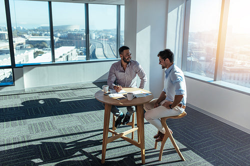 Business investors discussing business sitting at table in office