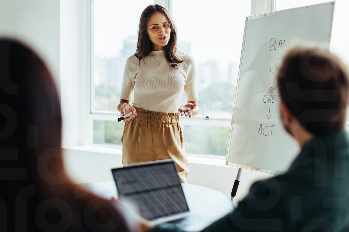 Female professional giving a presentation in an office – Jacob Lund ...