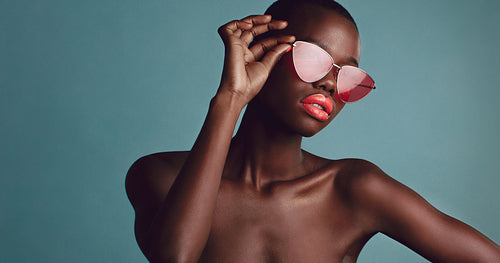 Beautiful woman in sunglasses and red lipstick
