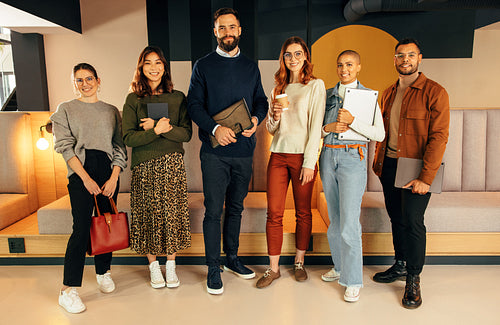 Successful businesspeople standing together in a lobby