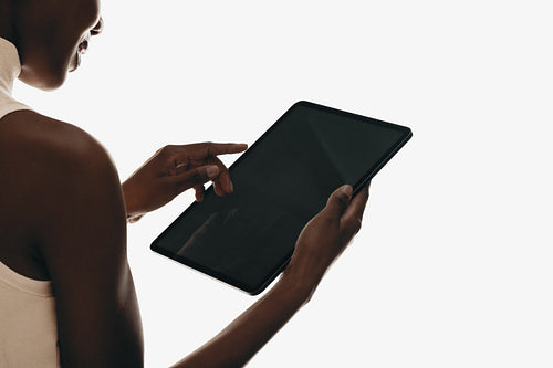 Person using a tablet device for interaction in a studio setting